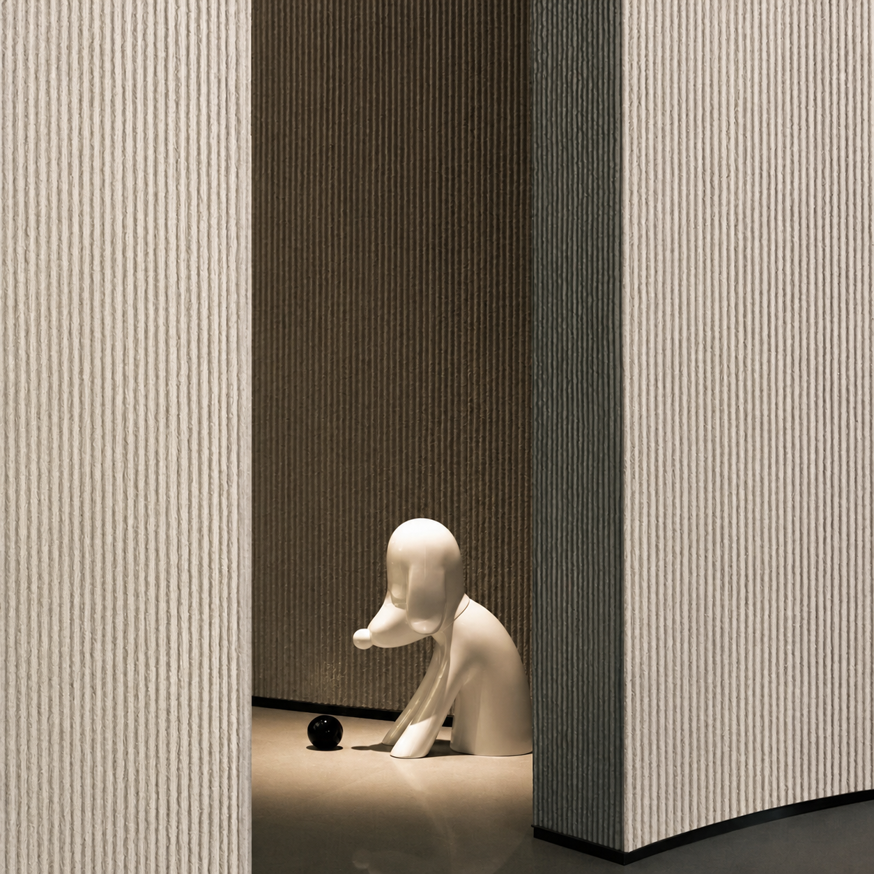 Sculptural interior featuring vertically textured flexible stone wall surfaces